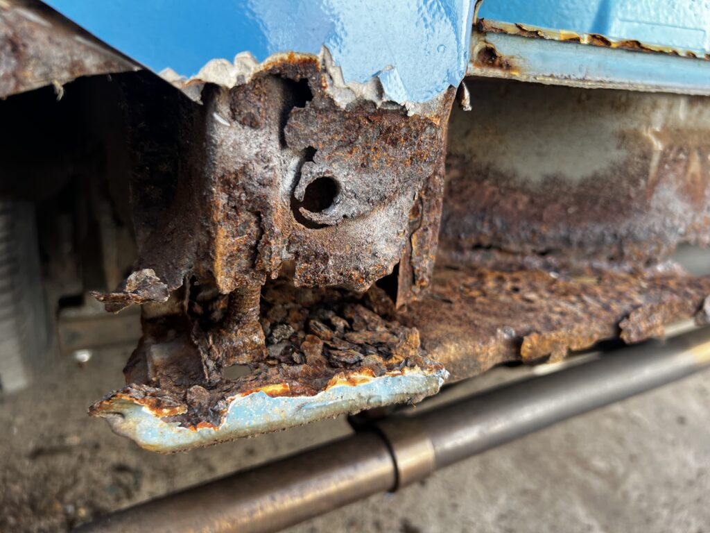 Hidden rust inside a classic VW Camper van.