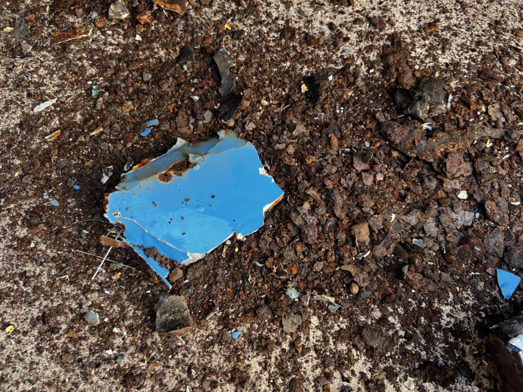 Rust and filler that has fallen out from the VW Camper Van.